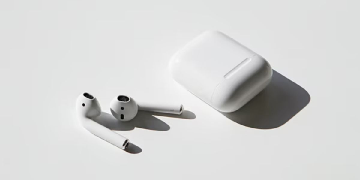 airpods and airpods case on white surface