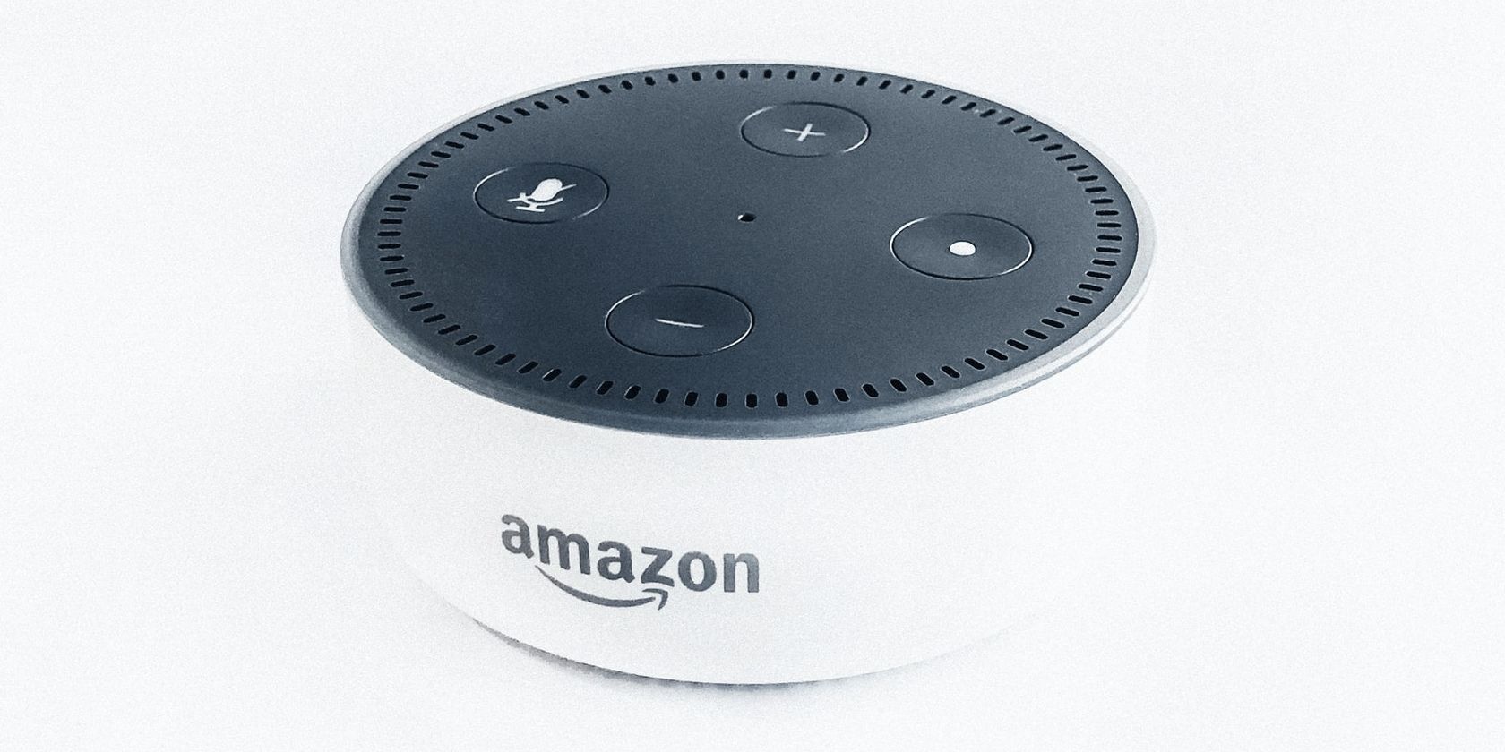 White Alexa device with Amazon logo.