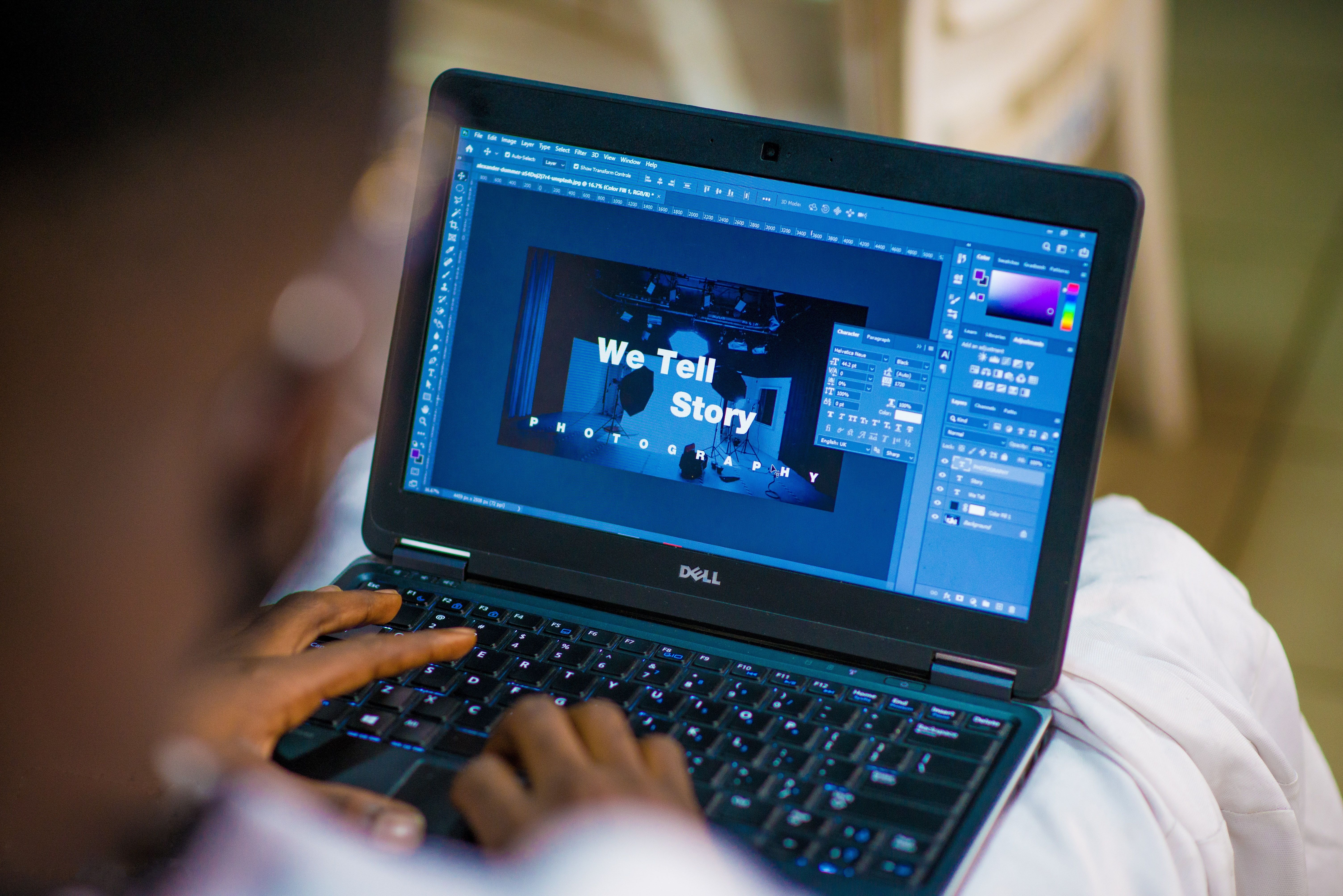 A person adjusting a graphic design layout in Photoshop.