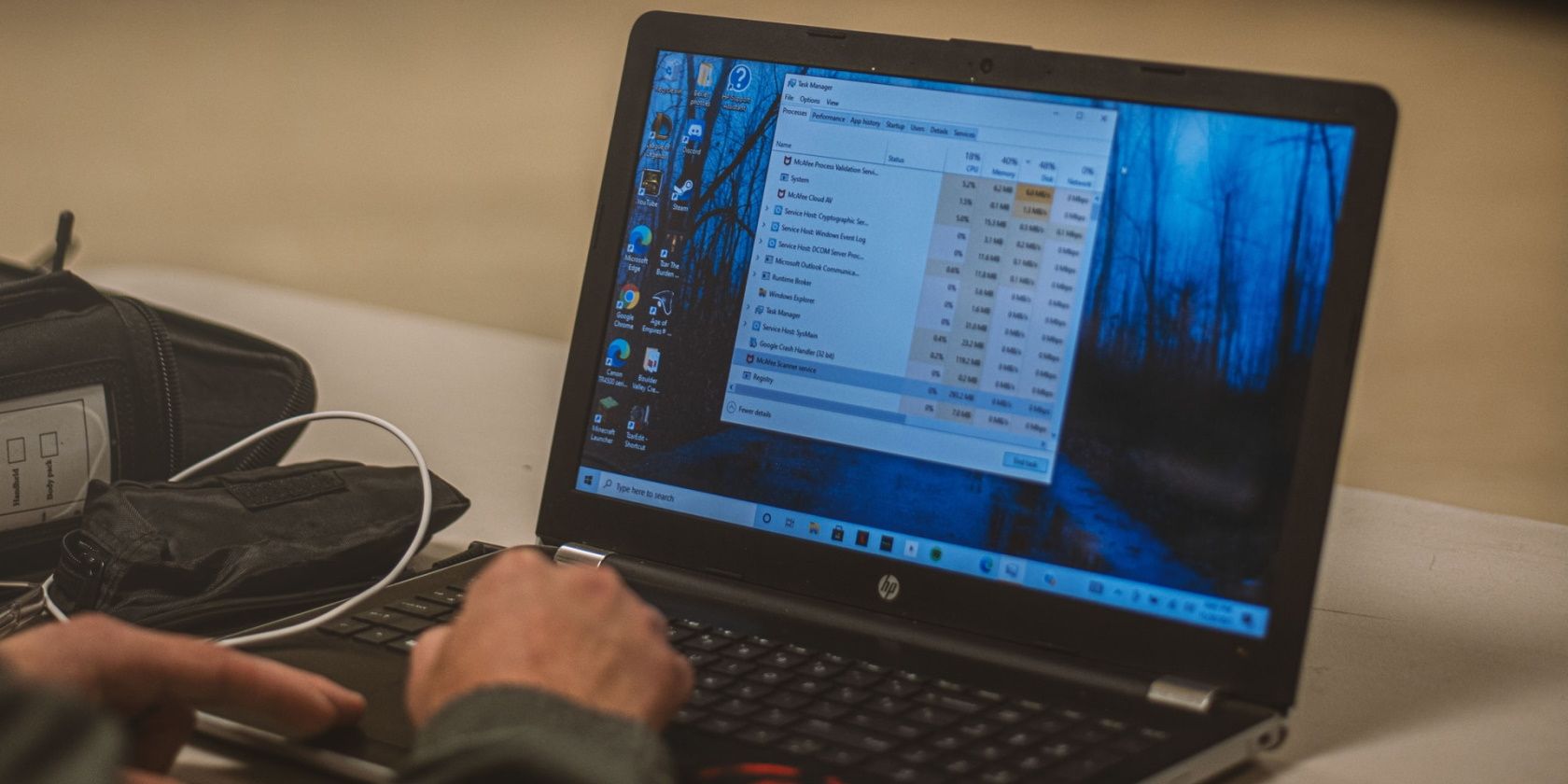 closeup of a laptop running windows 10 with a man scrolling via touchpad