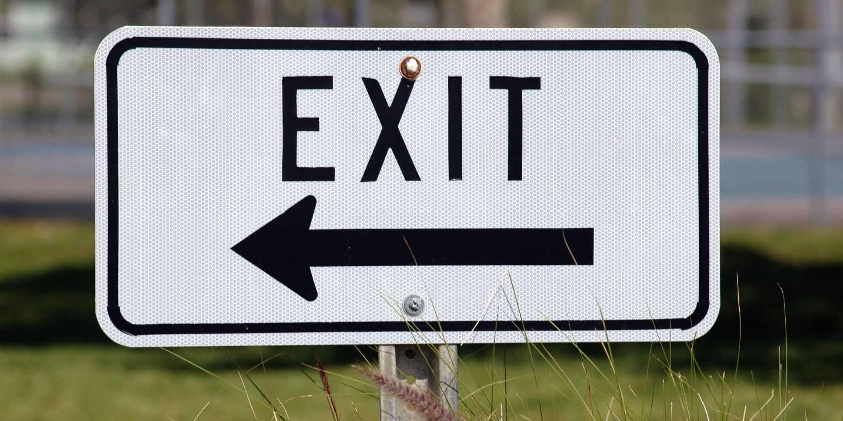 outdoor exit sign pointing left