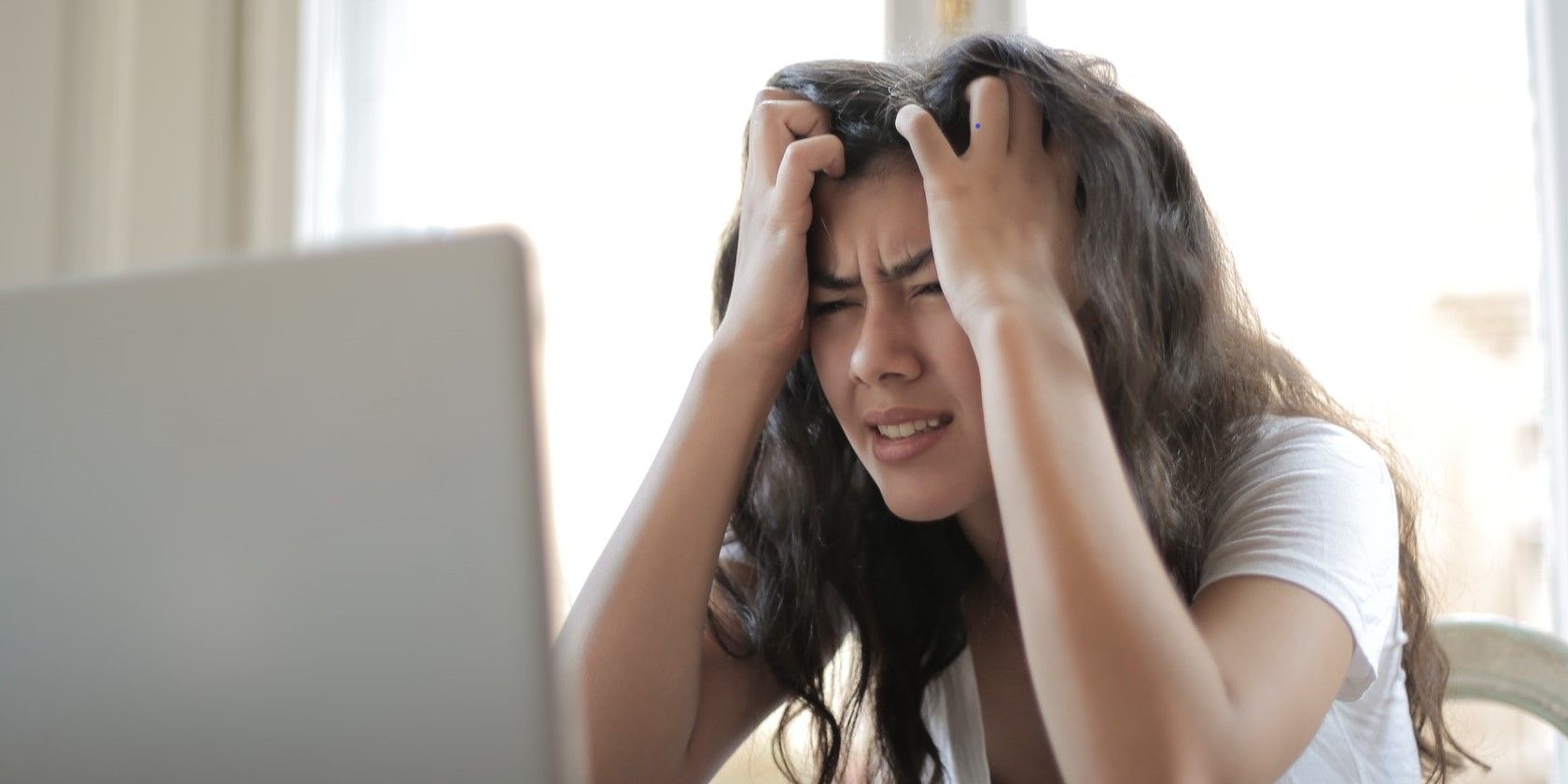 frustrated woman looking at laptop screen