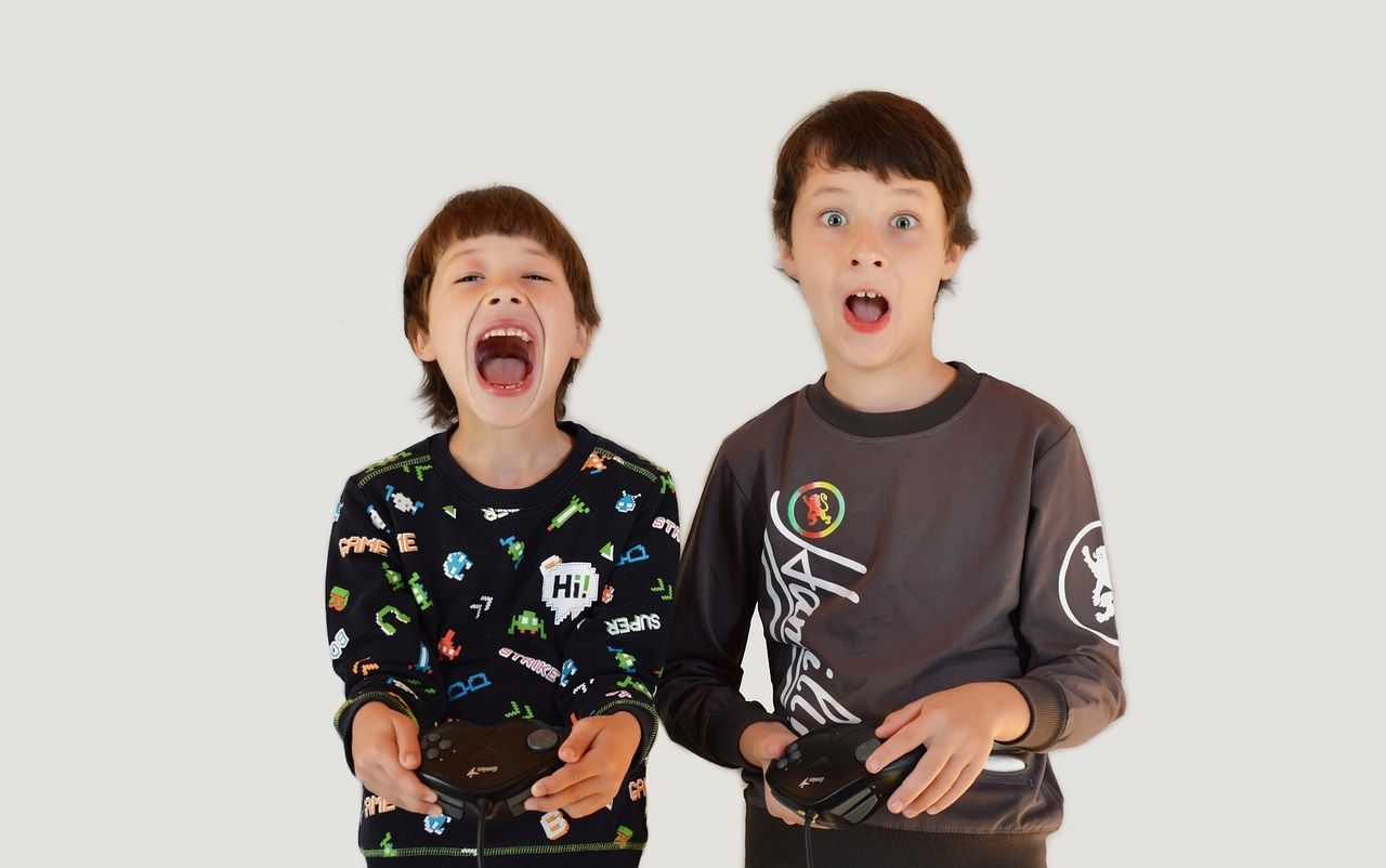 happy young gamers holding consoles