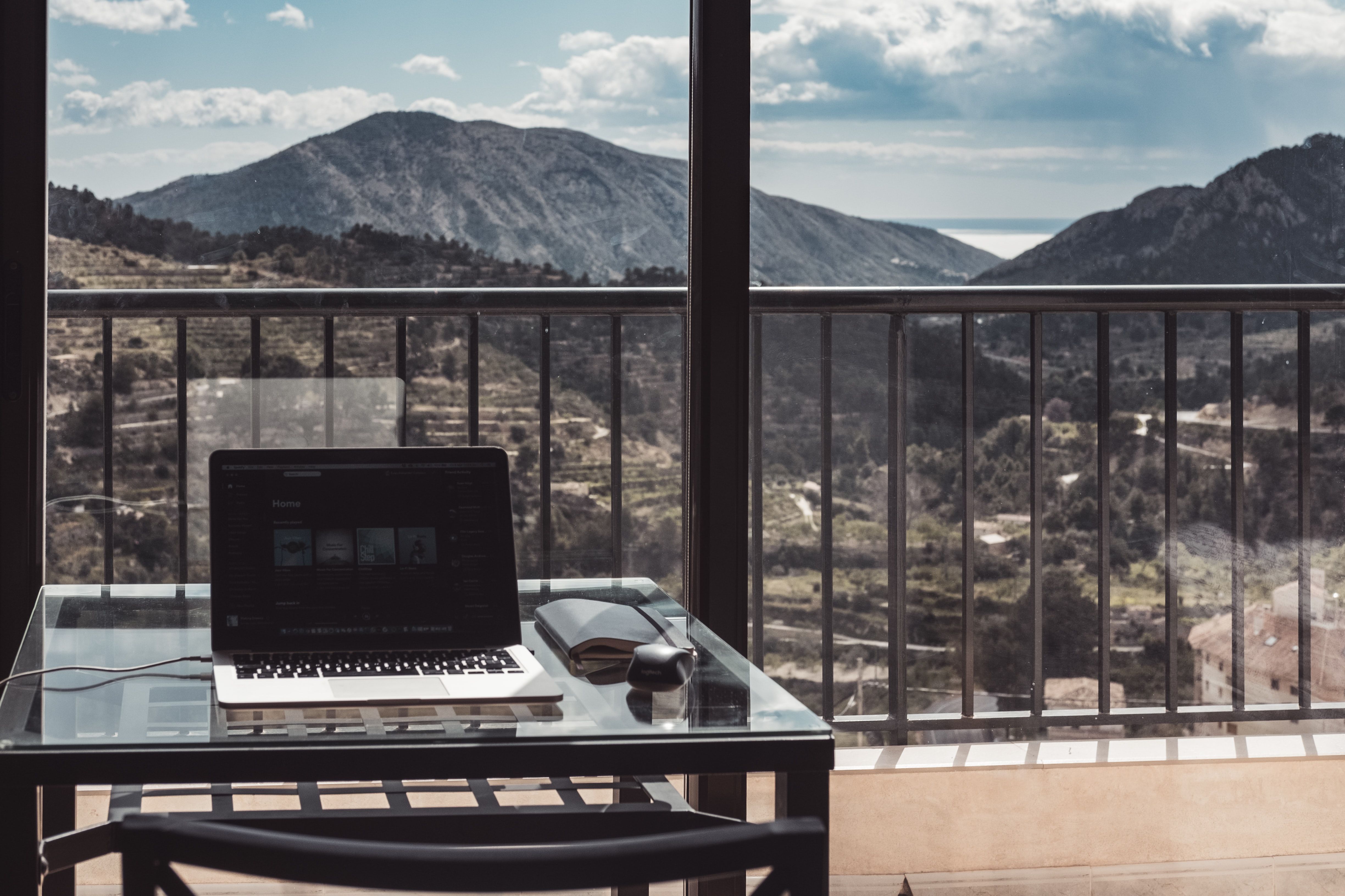 A person working remotely on a balcony.