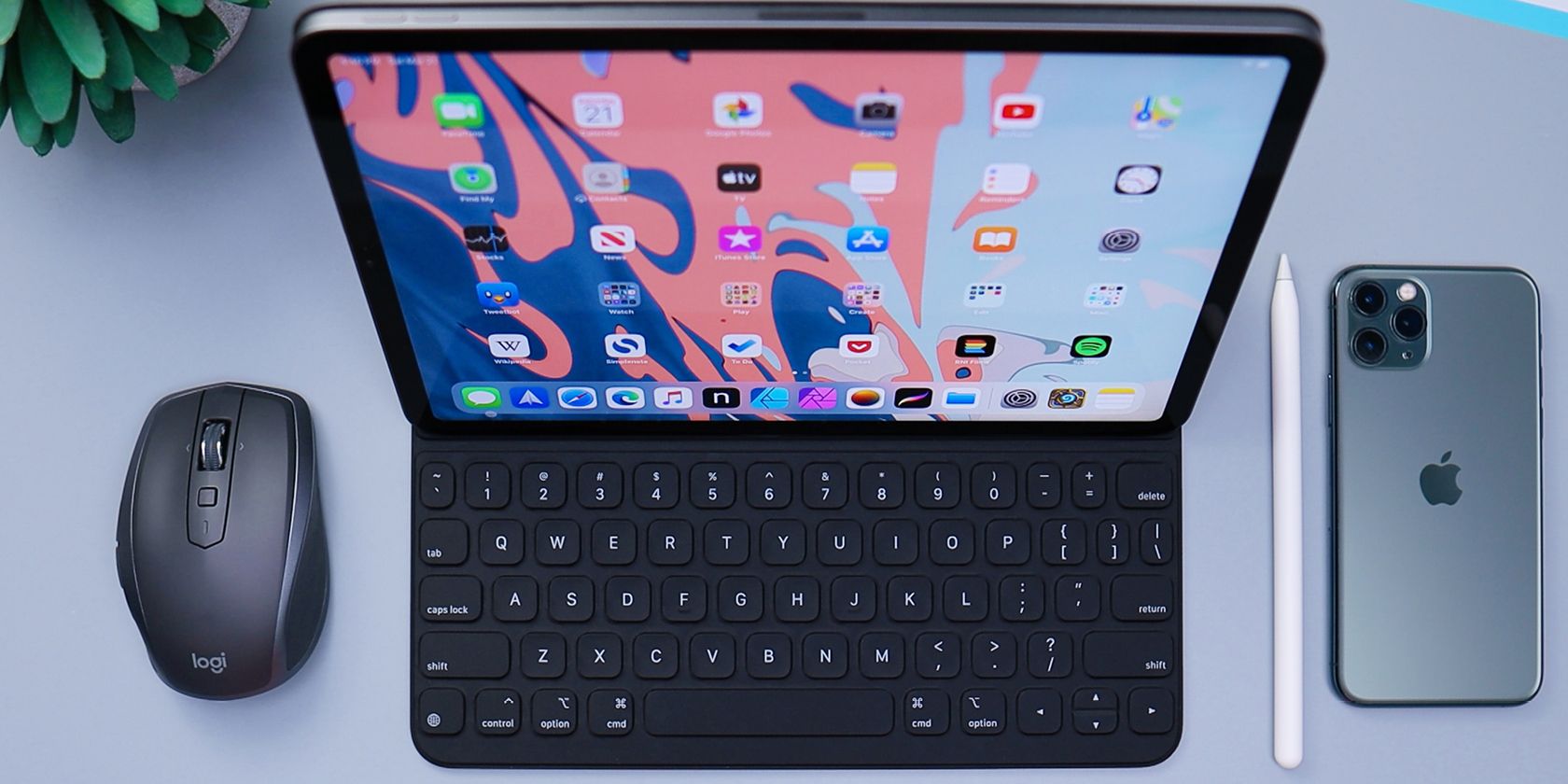 iPad Pro with keyboard case sitting on desk with mouse