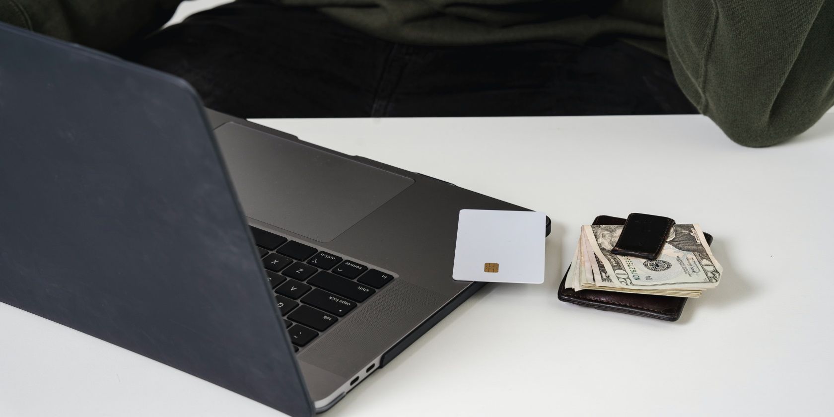 Laptop with cash and credit card