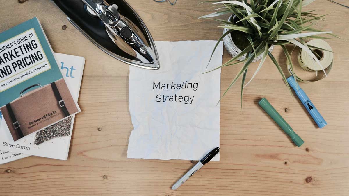 Paper on a desk with marketing strategy written on it