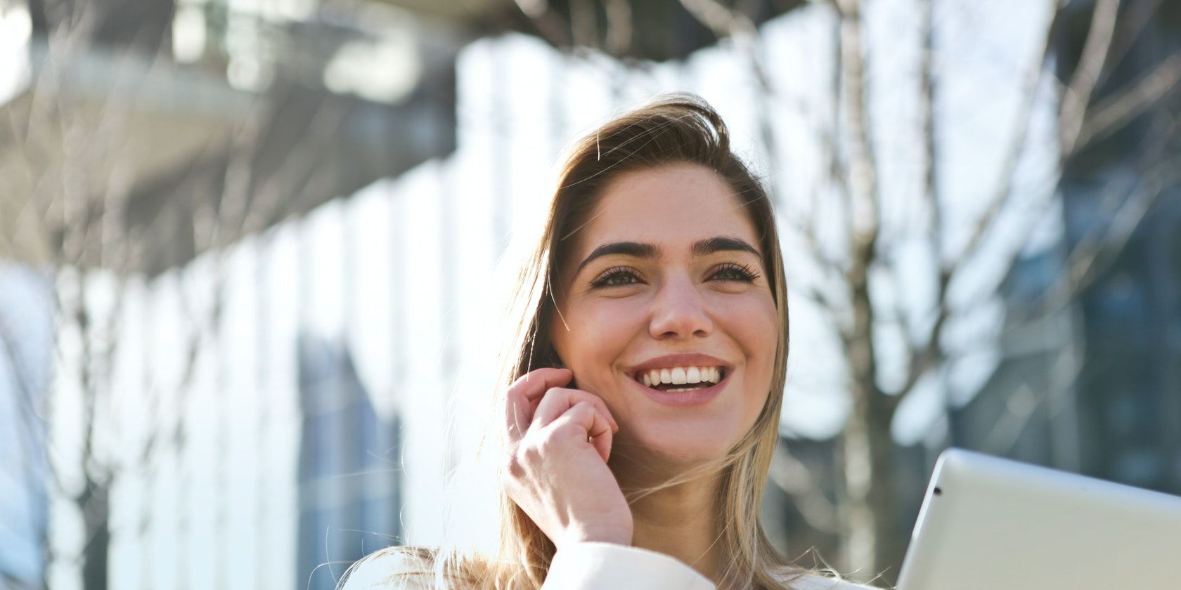 Woman smiling while talking on the phone