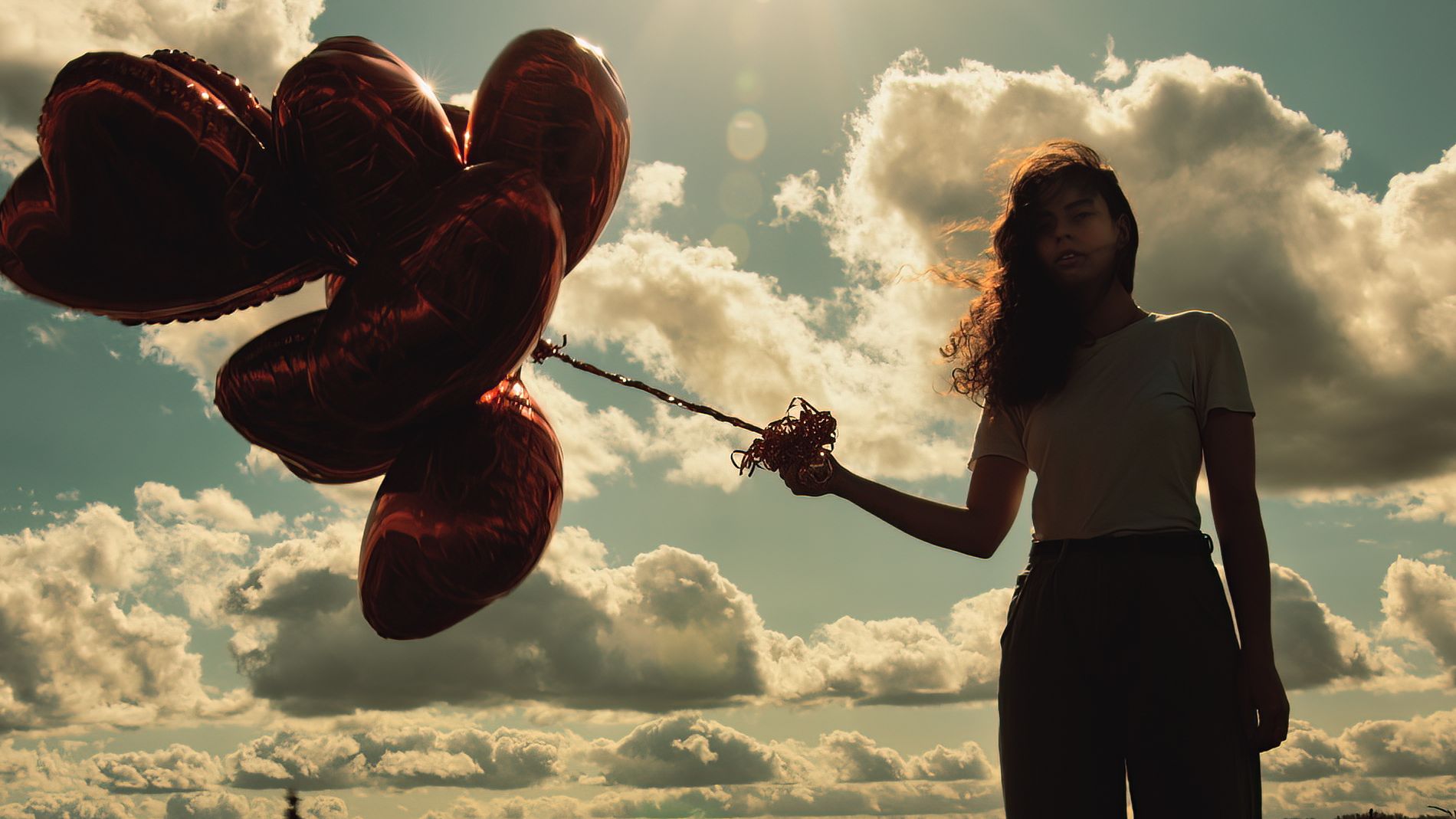 Backlit picture of a girl with balloons