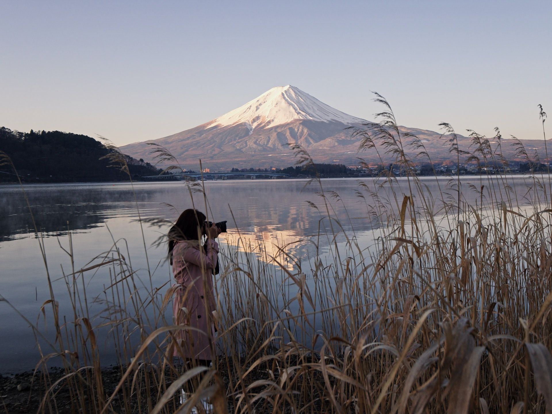 Photogarpher taking pictures near a mountain lake