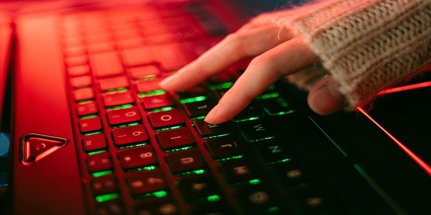 person pressing keys on keyboard