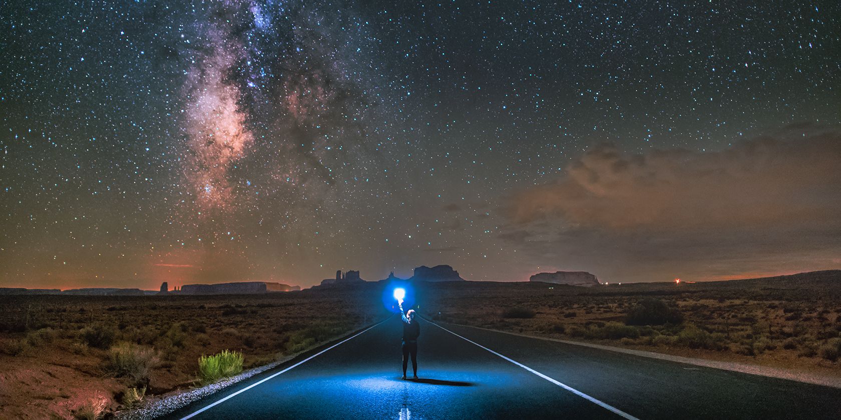 Person on a desert highway at night