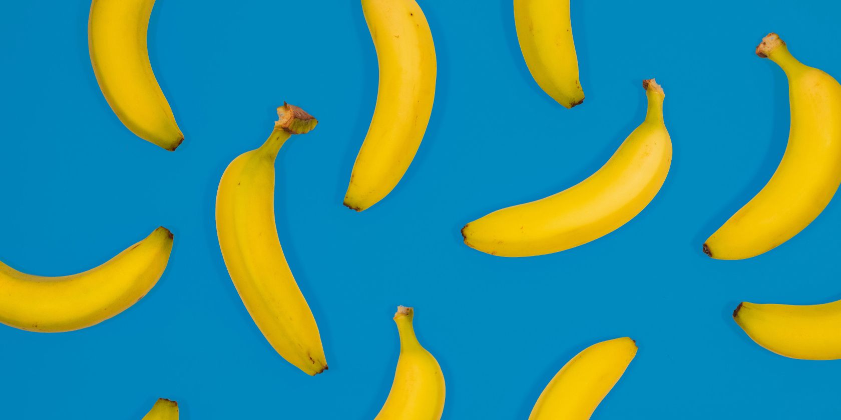 Some bananas on a blue field.