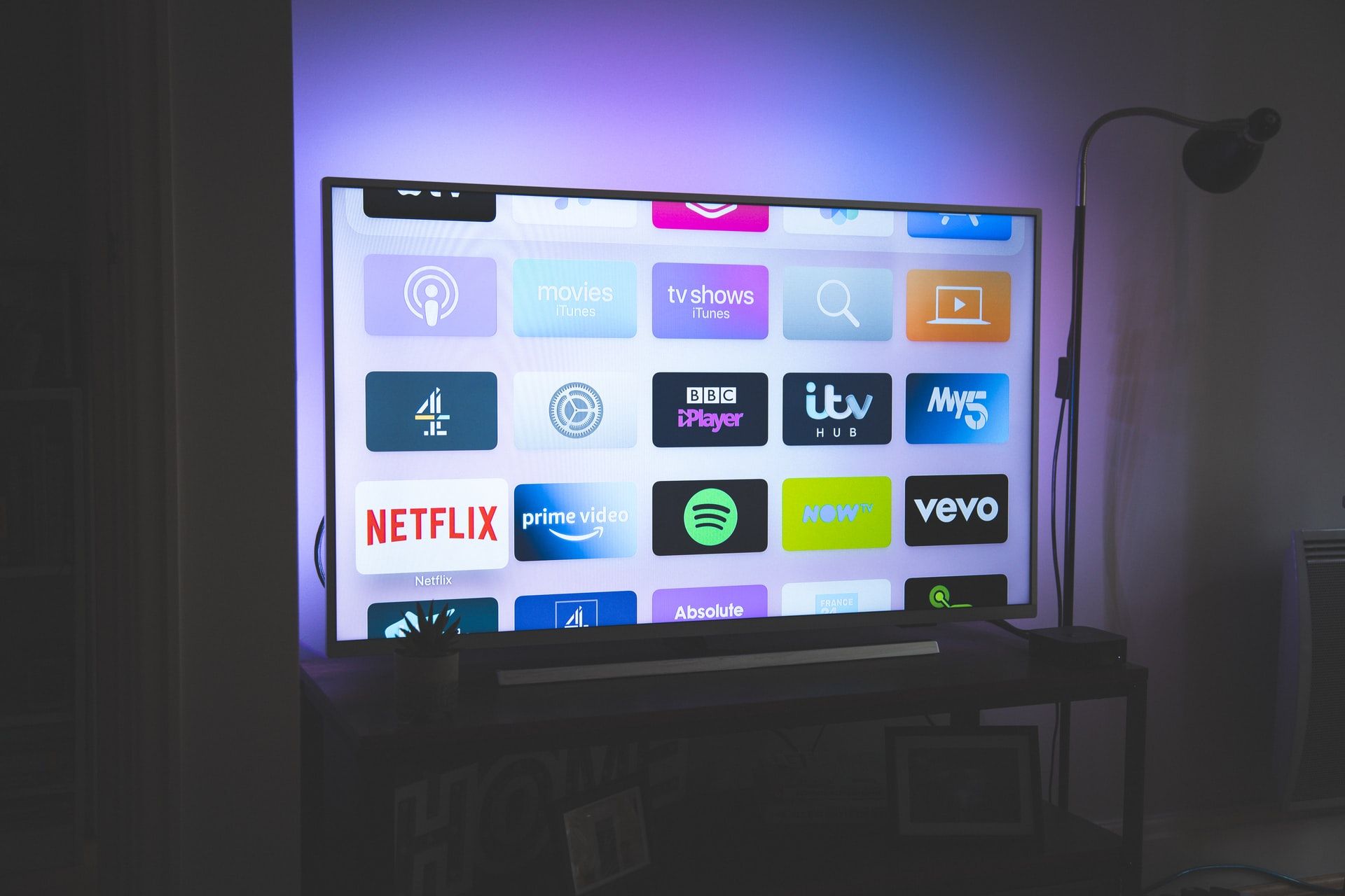 smart 4k hd tv television in dark living room with apps