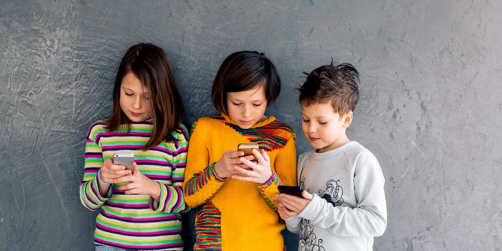 kids looking at their smartphone devices