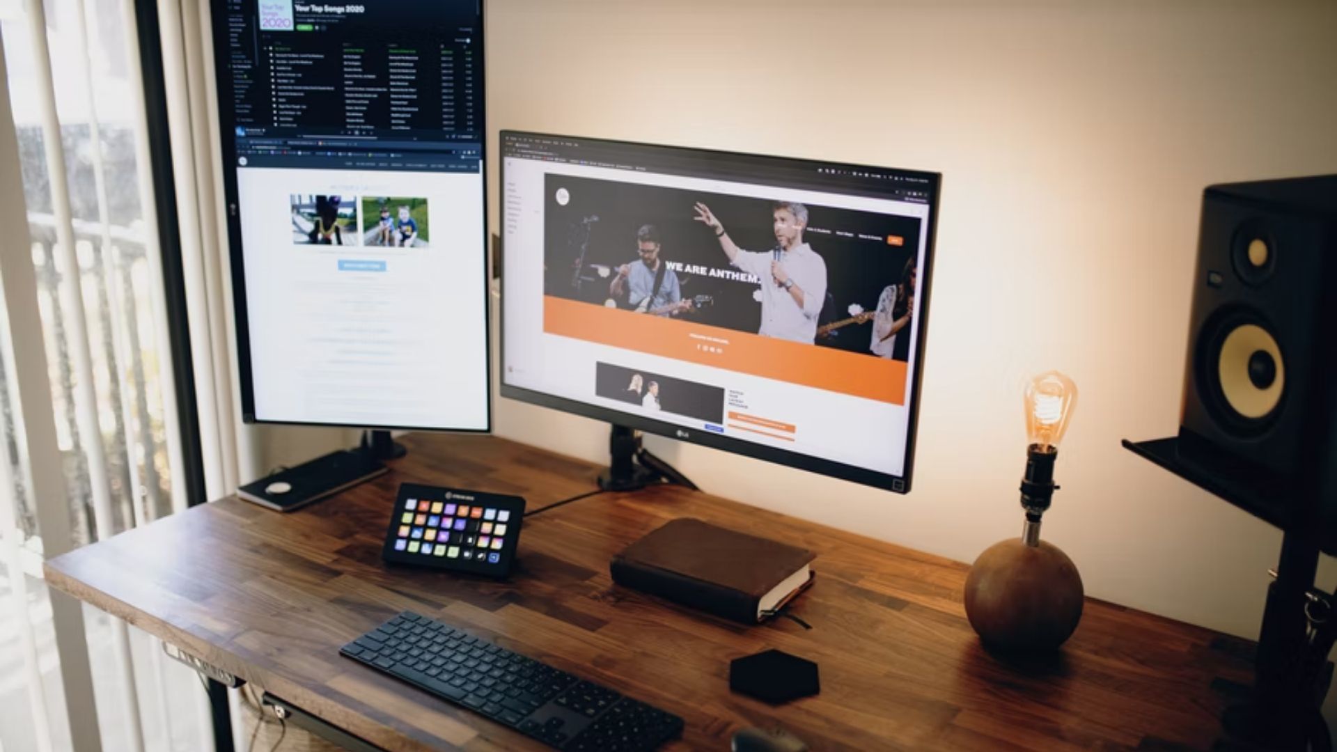 vertical monitor set up on a wooden desk next to a horizontal monitor