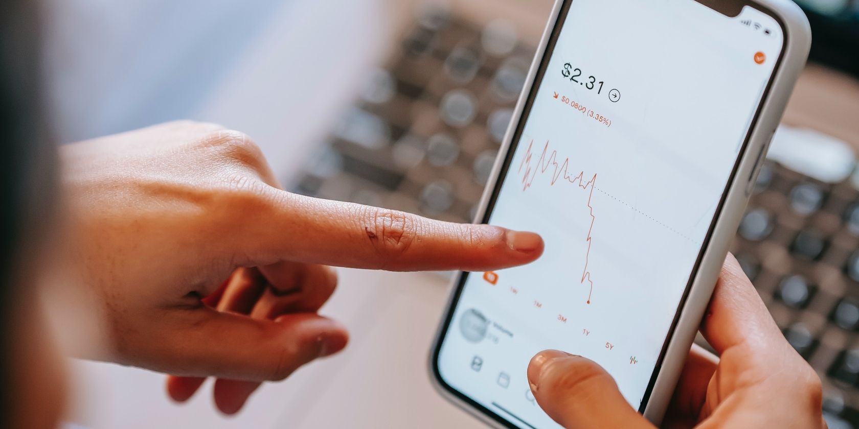 person checking stock price with a line chart on phone
