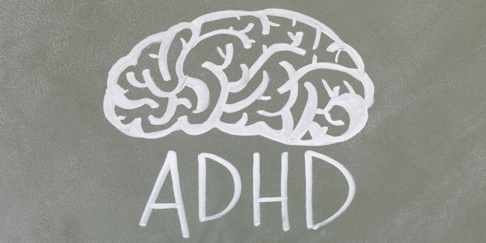 Human brain and the letters ADHD drawn on chalkboard