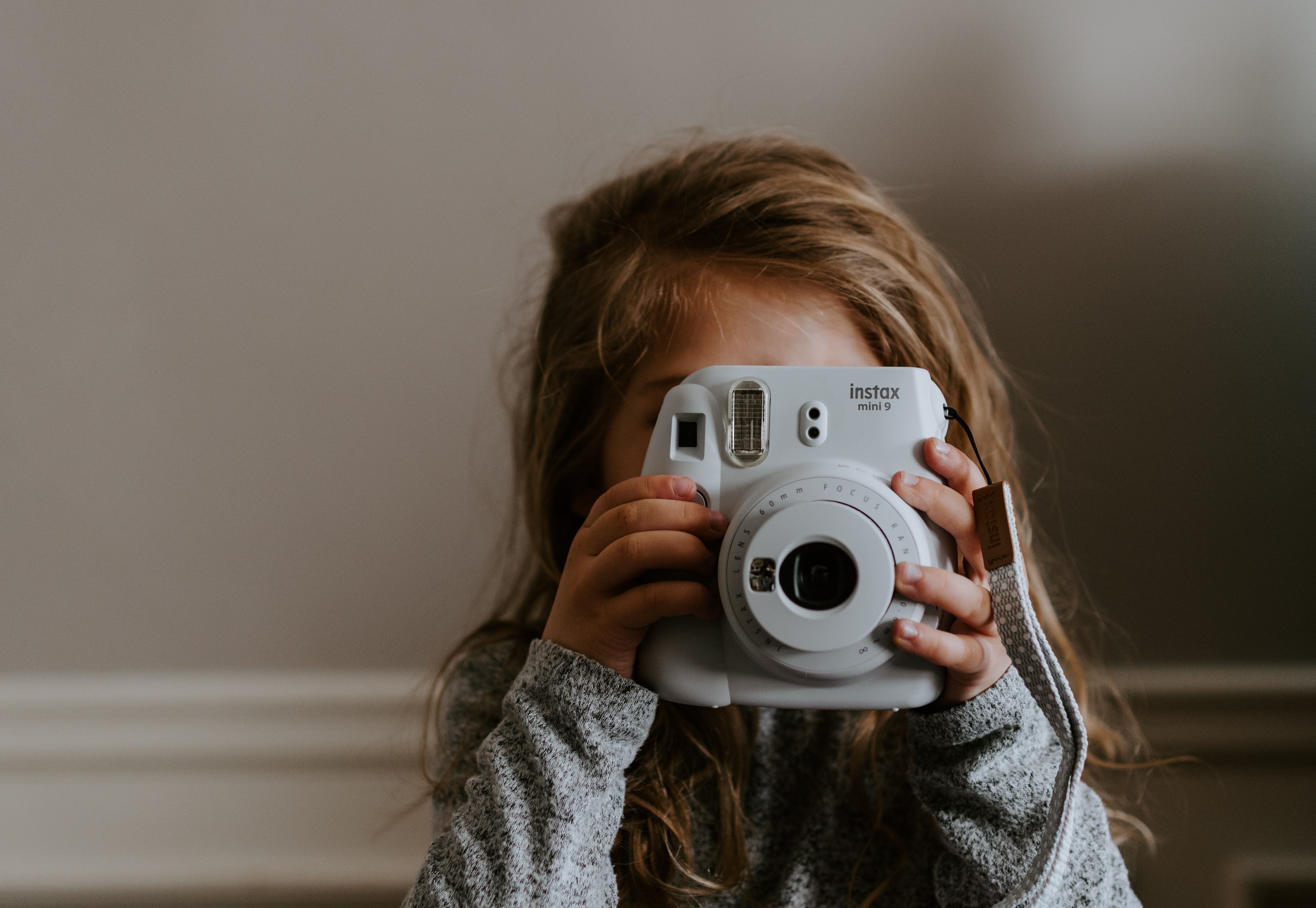 Photo of a child using a camera