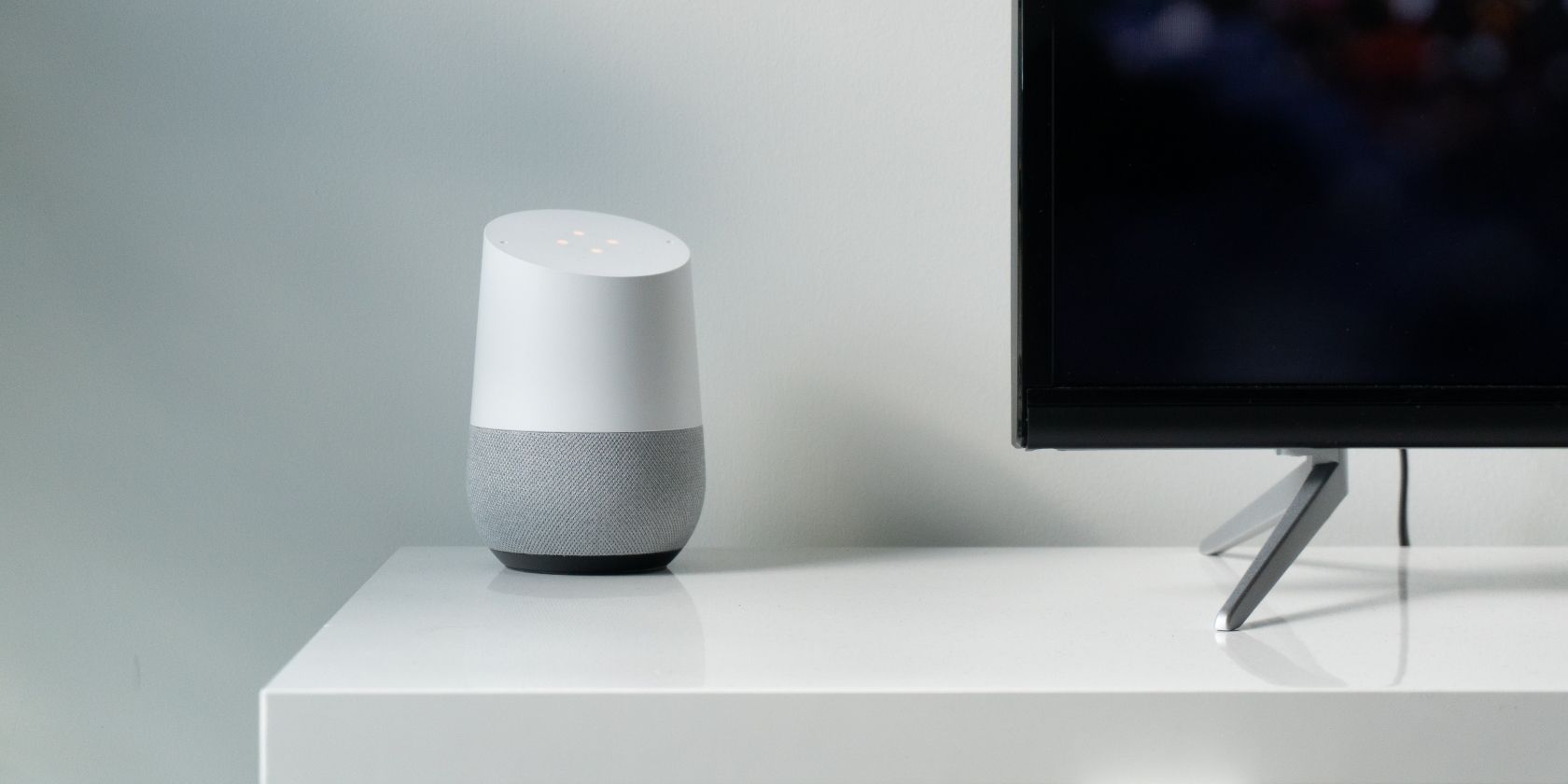 A Google Home Smart Speaker Next to a TV