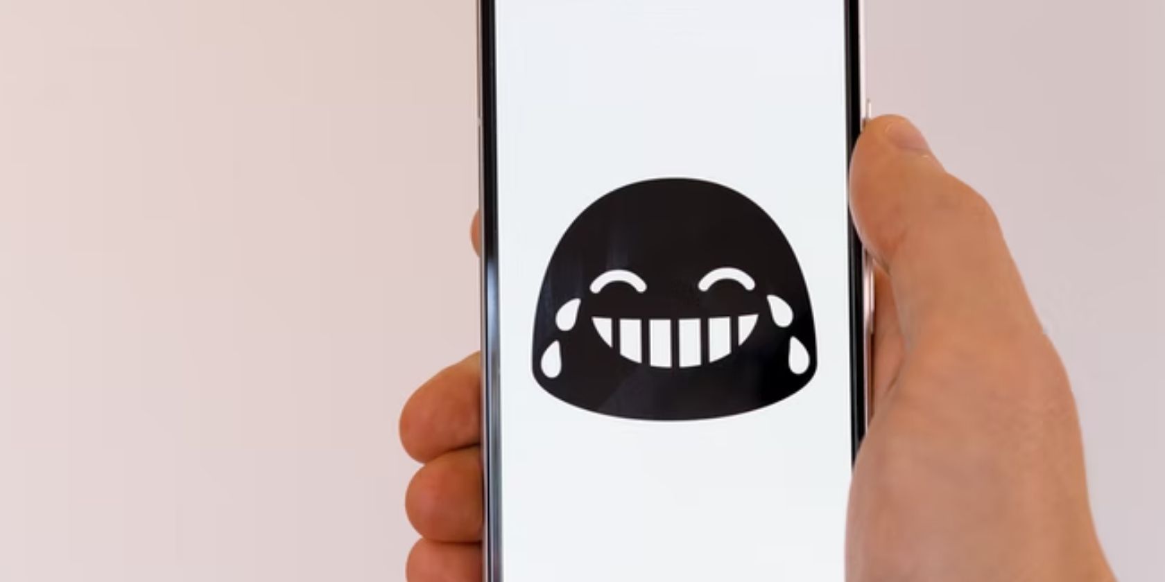 laughing and crying reaction icon on white smartphone background