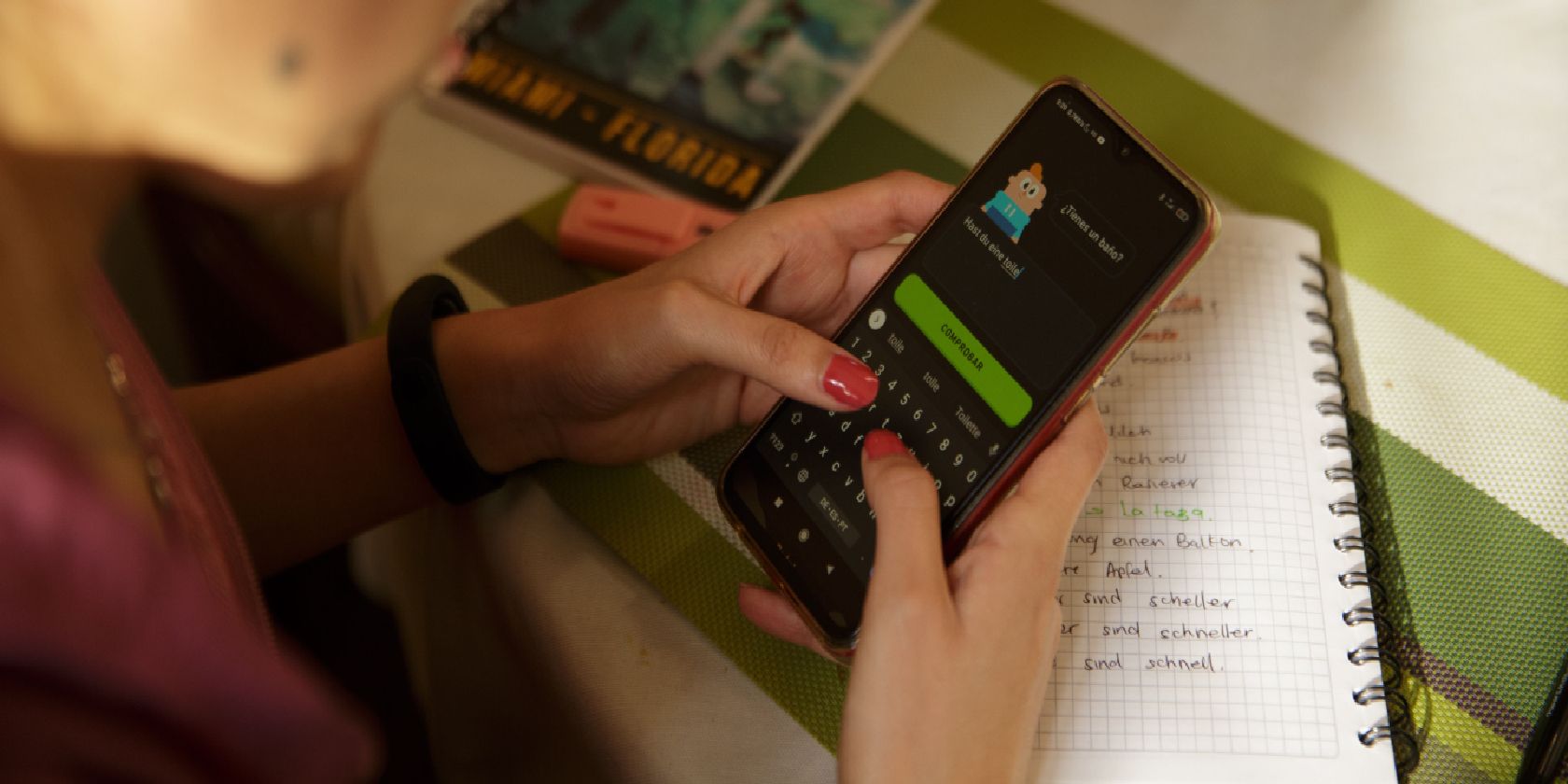 Woman using Duolingo on a smart phone.