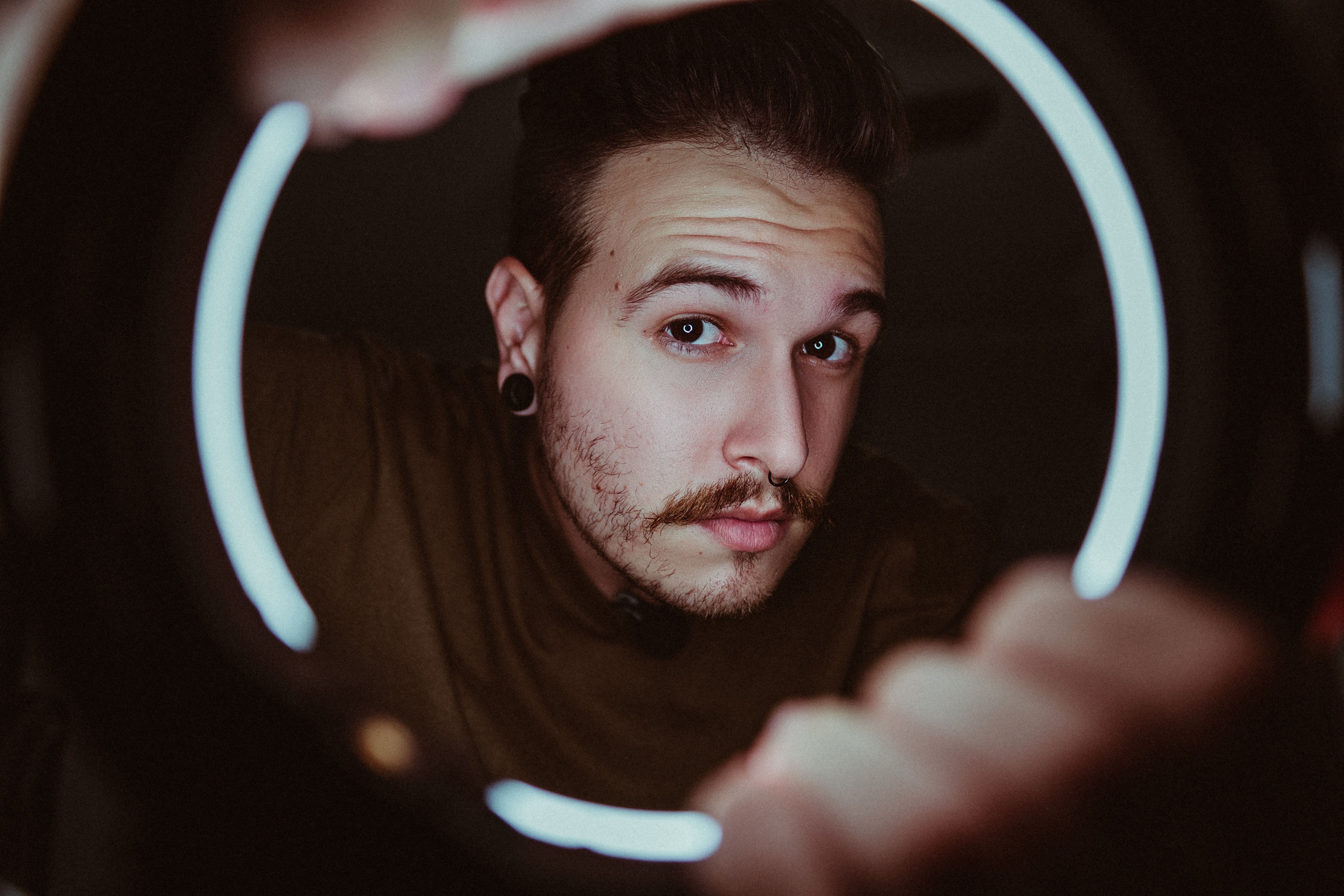 Photo of a person holding a ring light