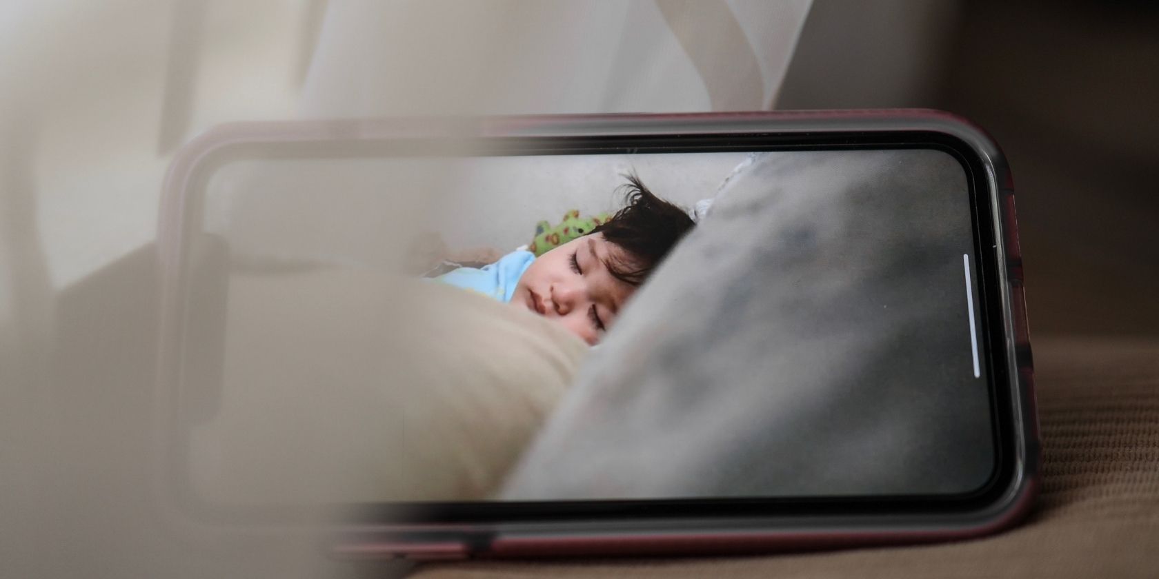 Screen of mobile phone with sleeping baby