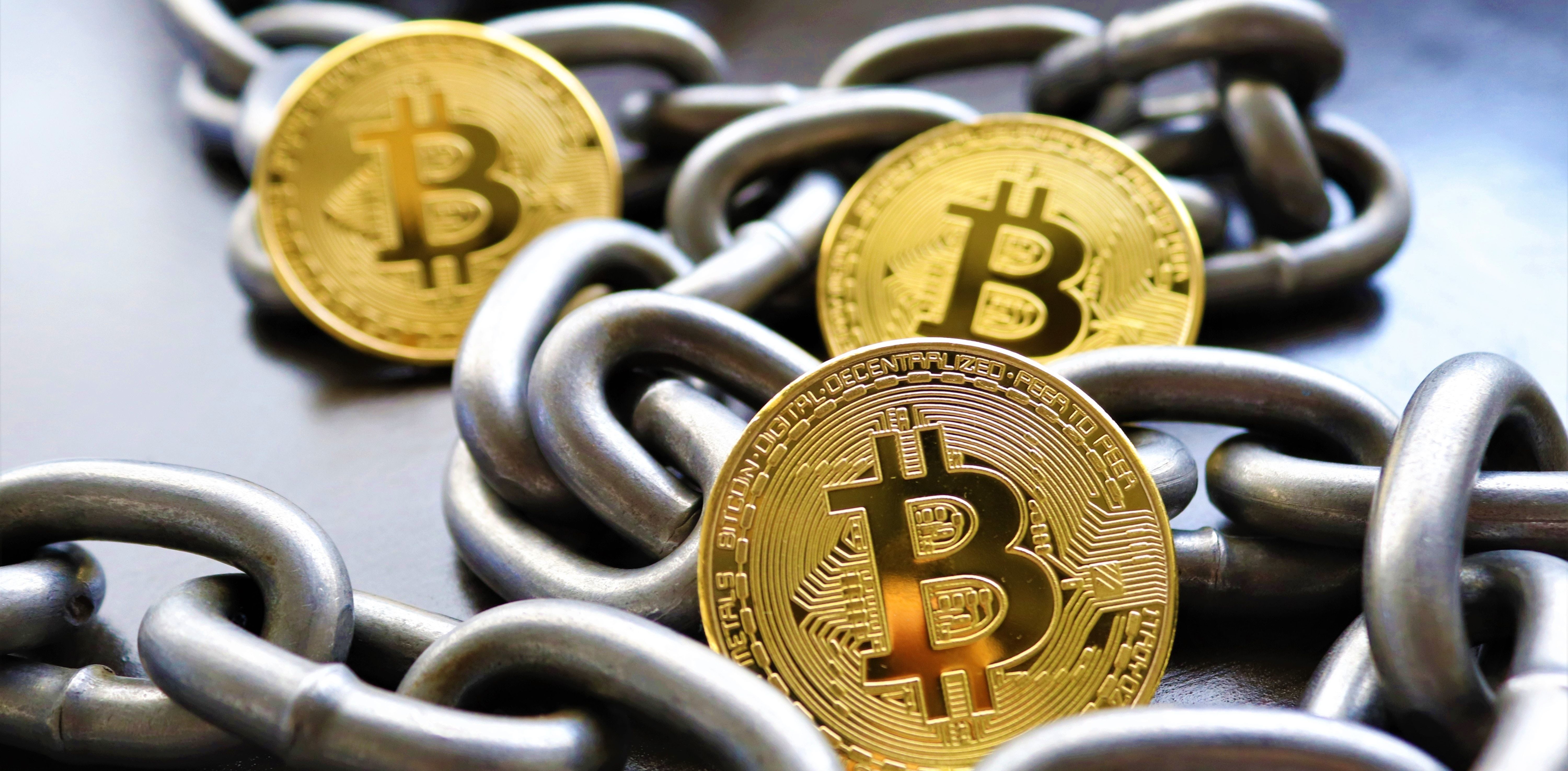 bitcoins and silver chain on desk