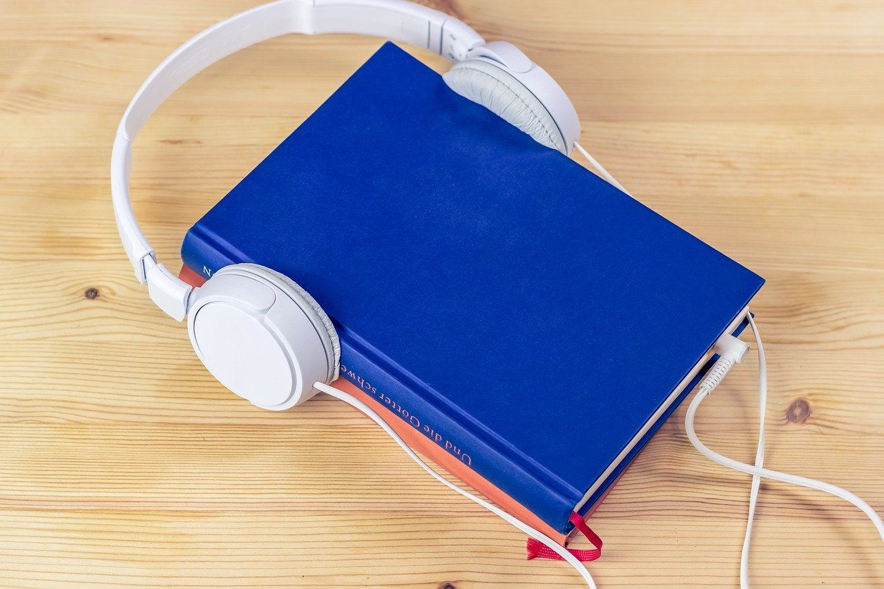 book with headphones wrapped around it