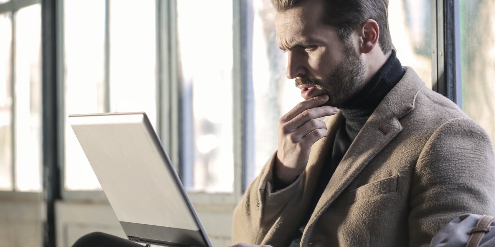 confused man in front of laptop