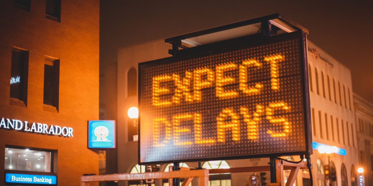 A digital sign displaying the words "expect delays"
