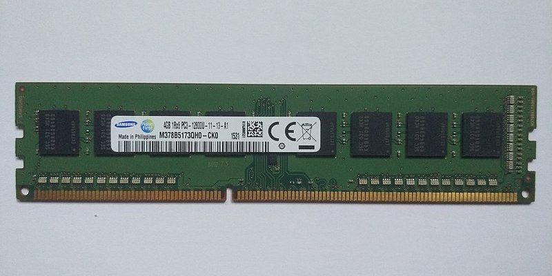 A green DIMM board with eight black chips and a strip of connectors at the bottom.