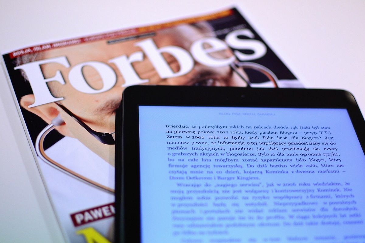 forbes magazine and tablet on top