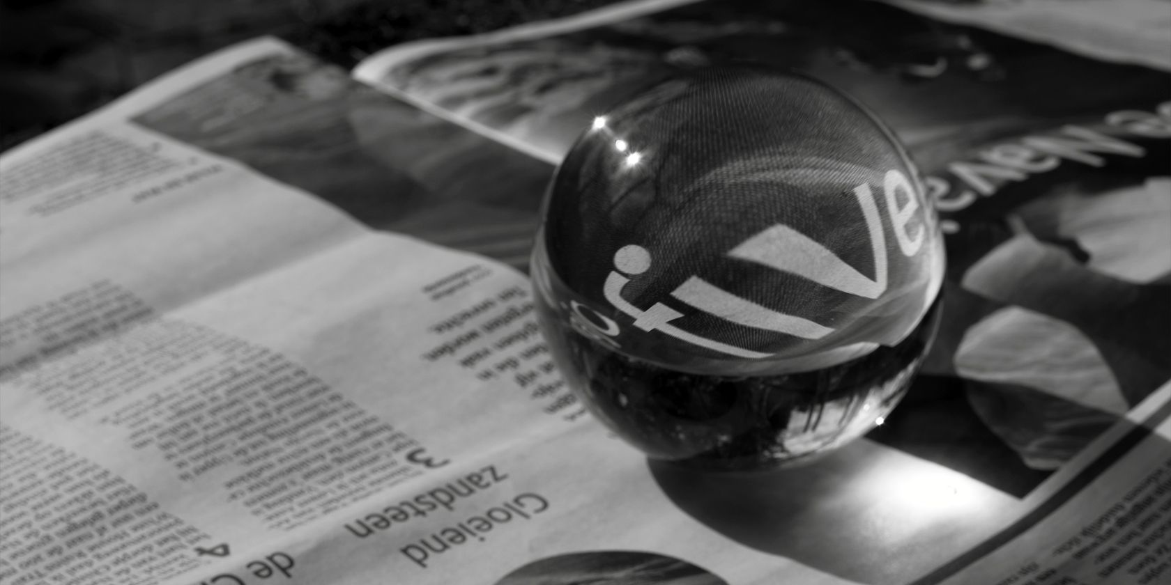 glass ball on a newspaper