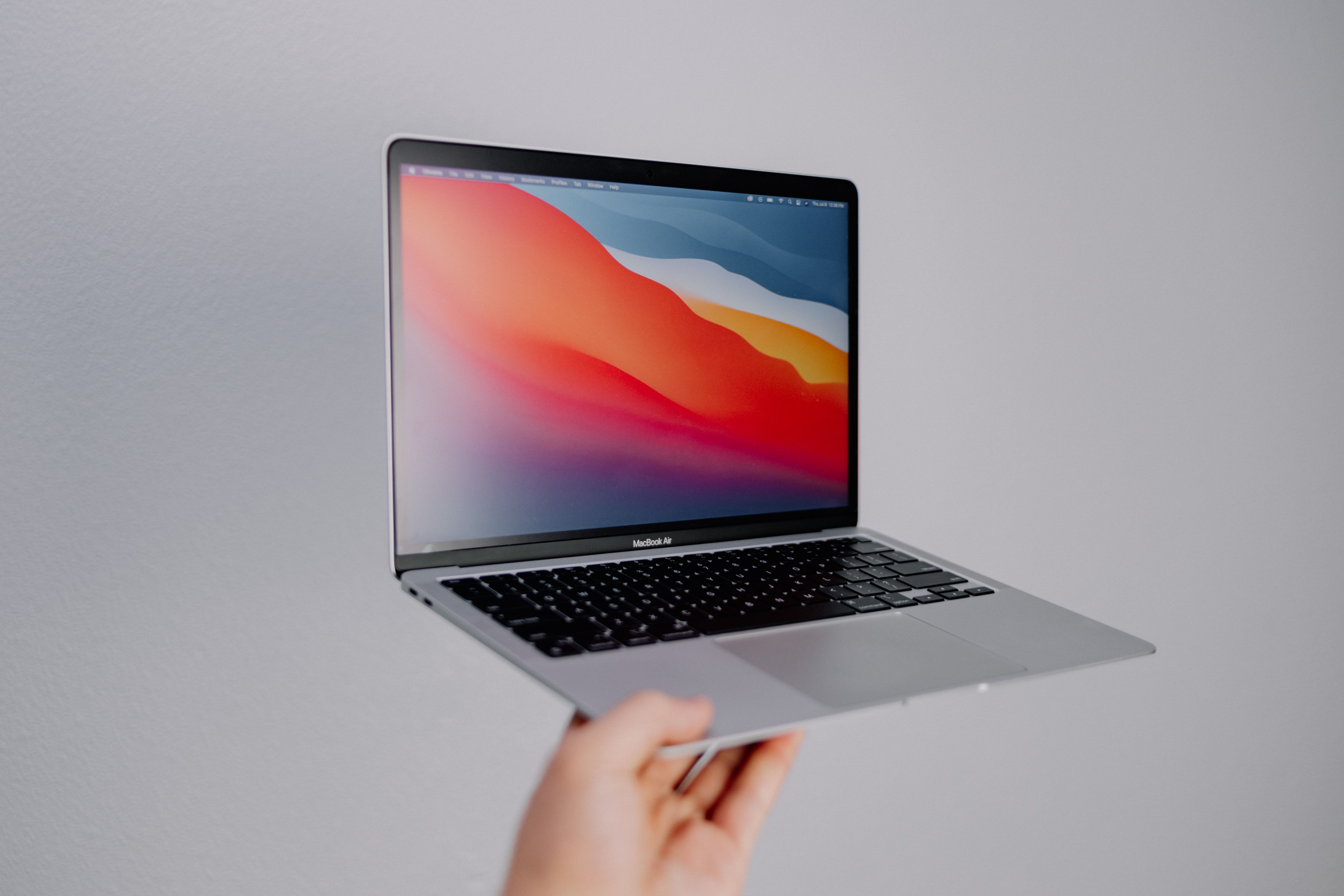 MacBook Air being held with white background 