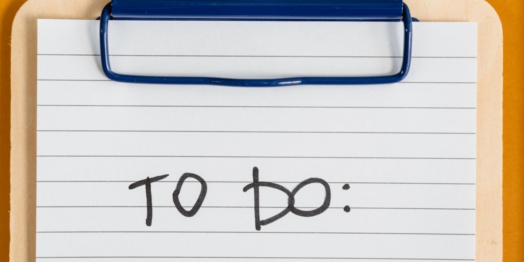 The words "TO DO" written on a clipboard.