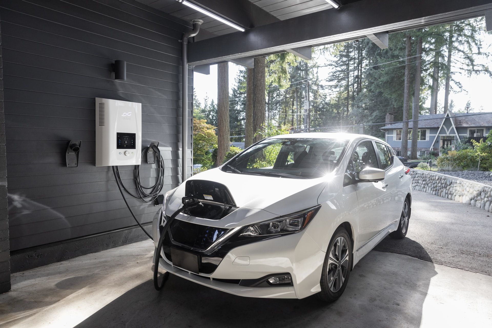 nissan leaf white charging in garage via level 2 home charger