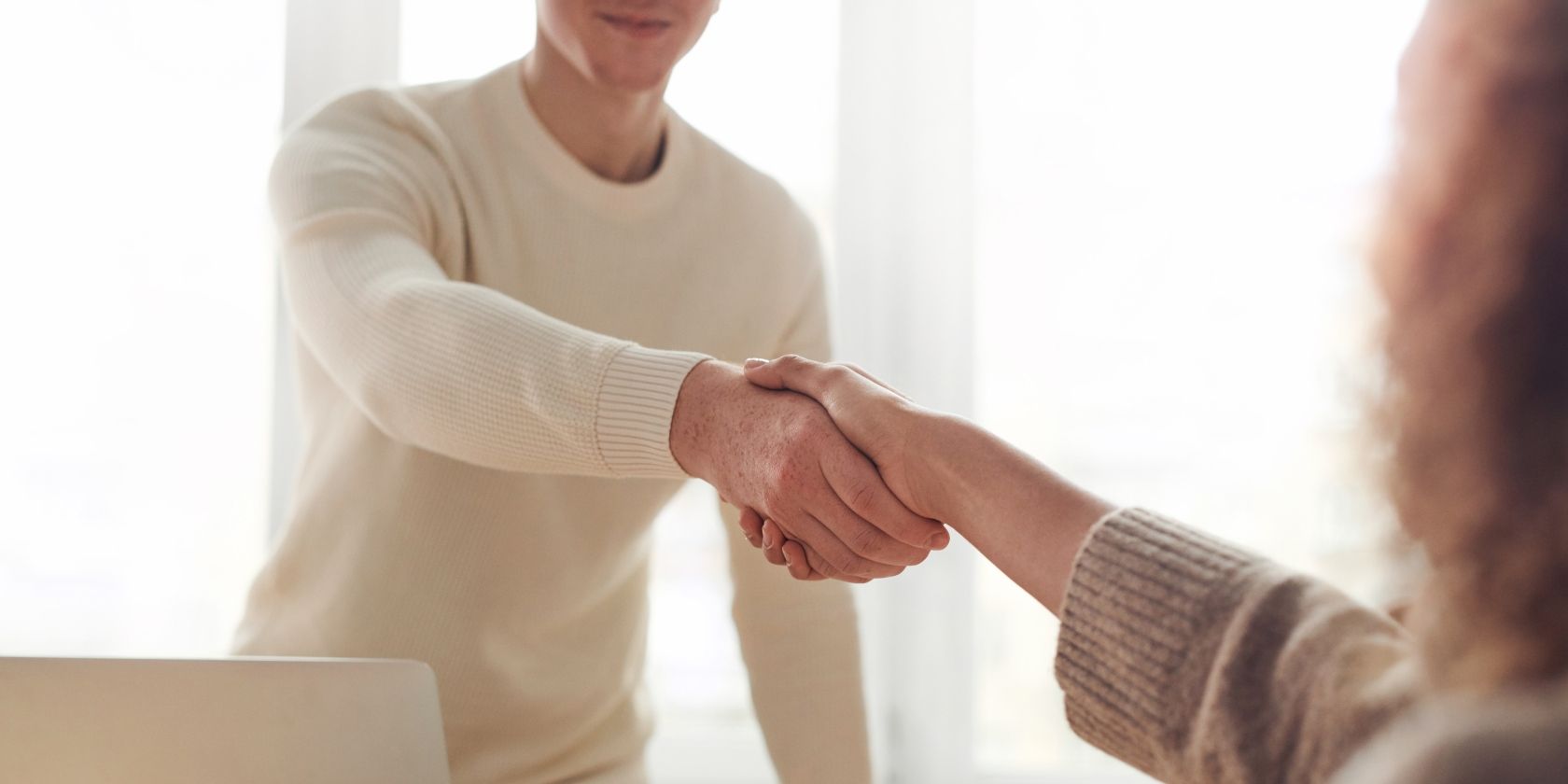 Photo of a man and woman shaking hands