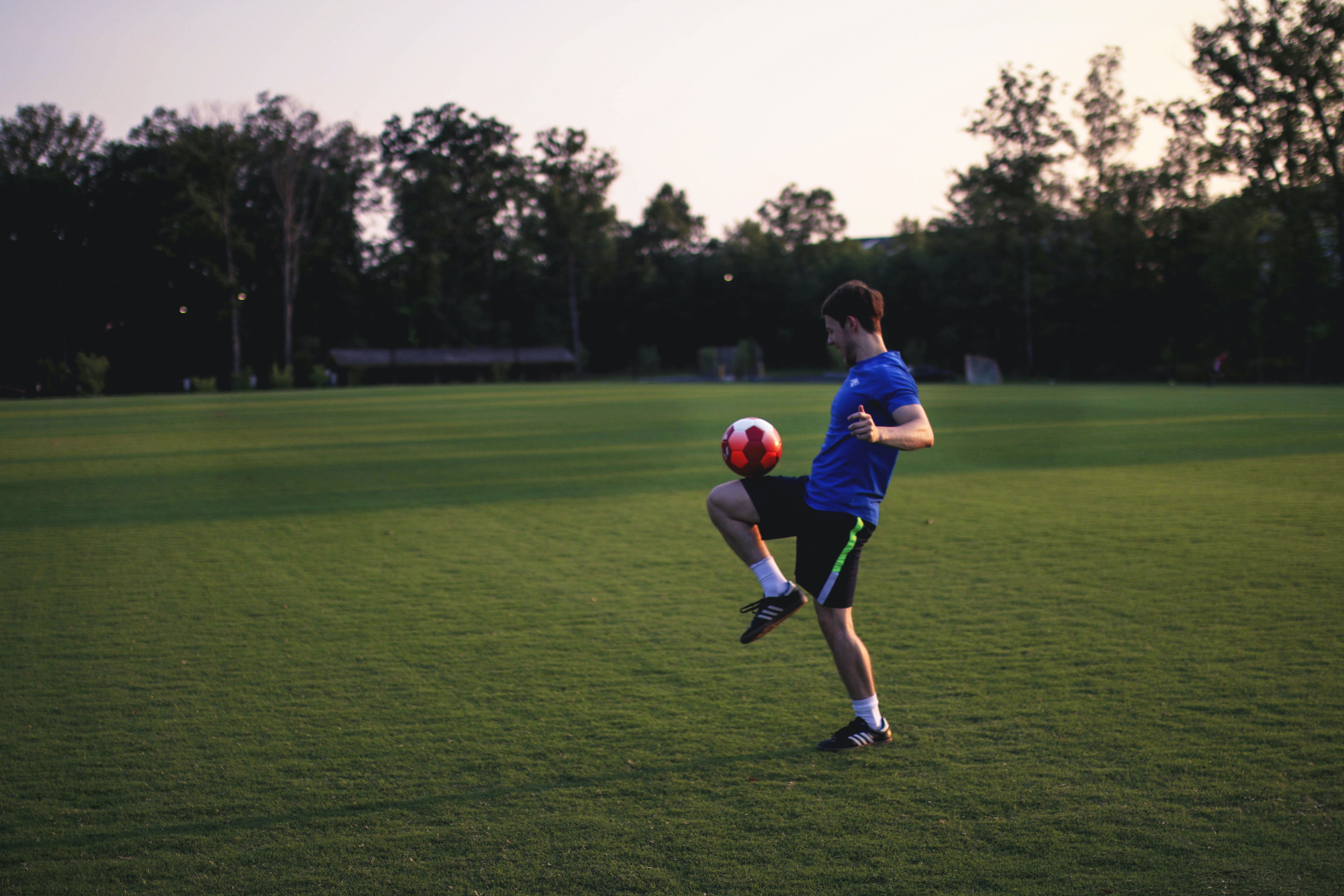 A boy dribbling a soccer ball.
