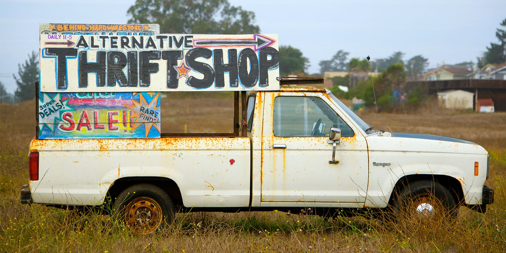 thrift shop sign on an old white truck