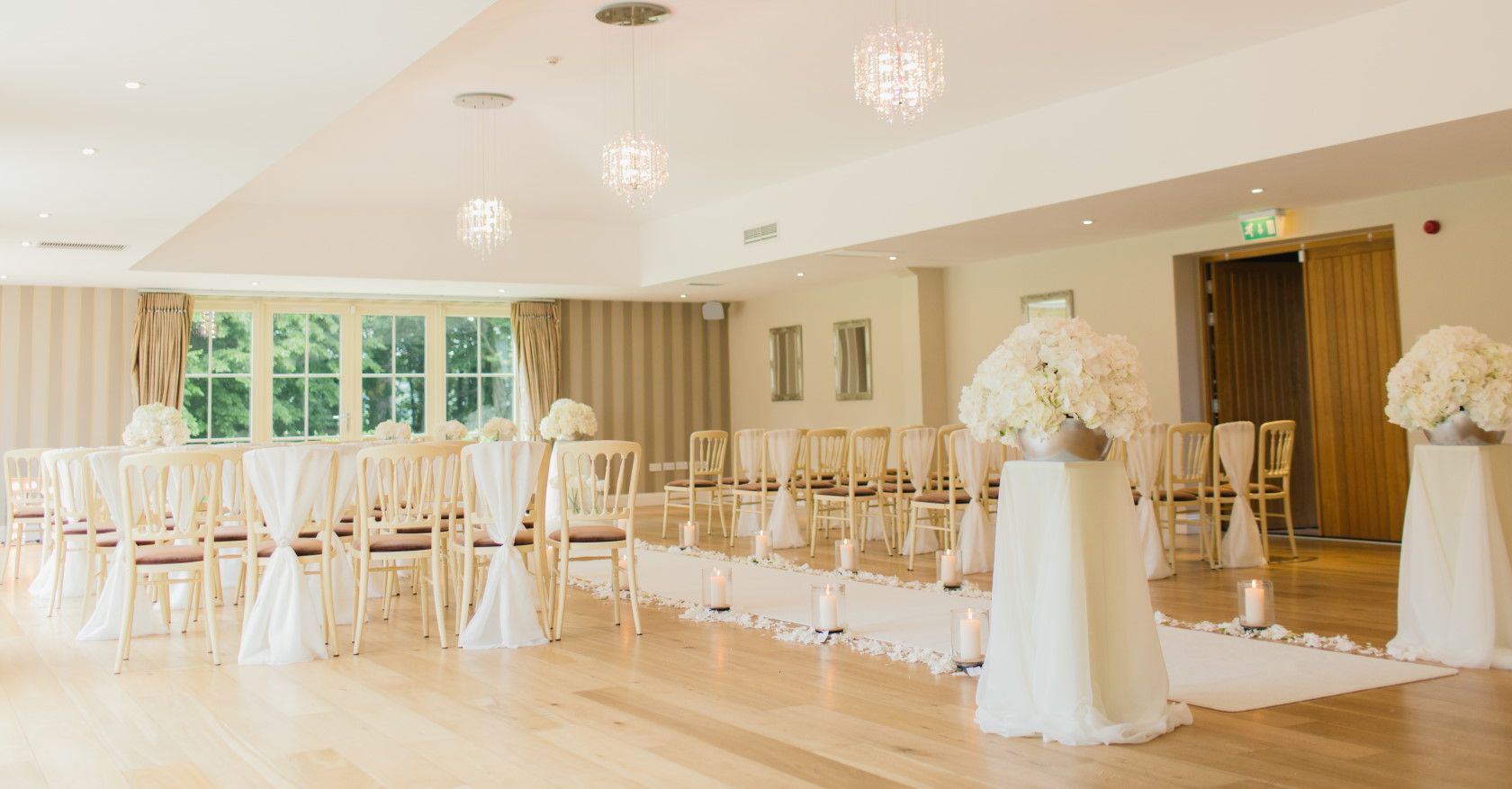 indoor wedding venue with flowers and white decorations