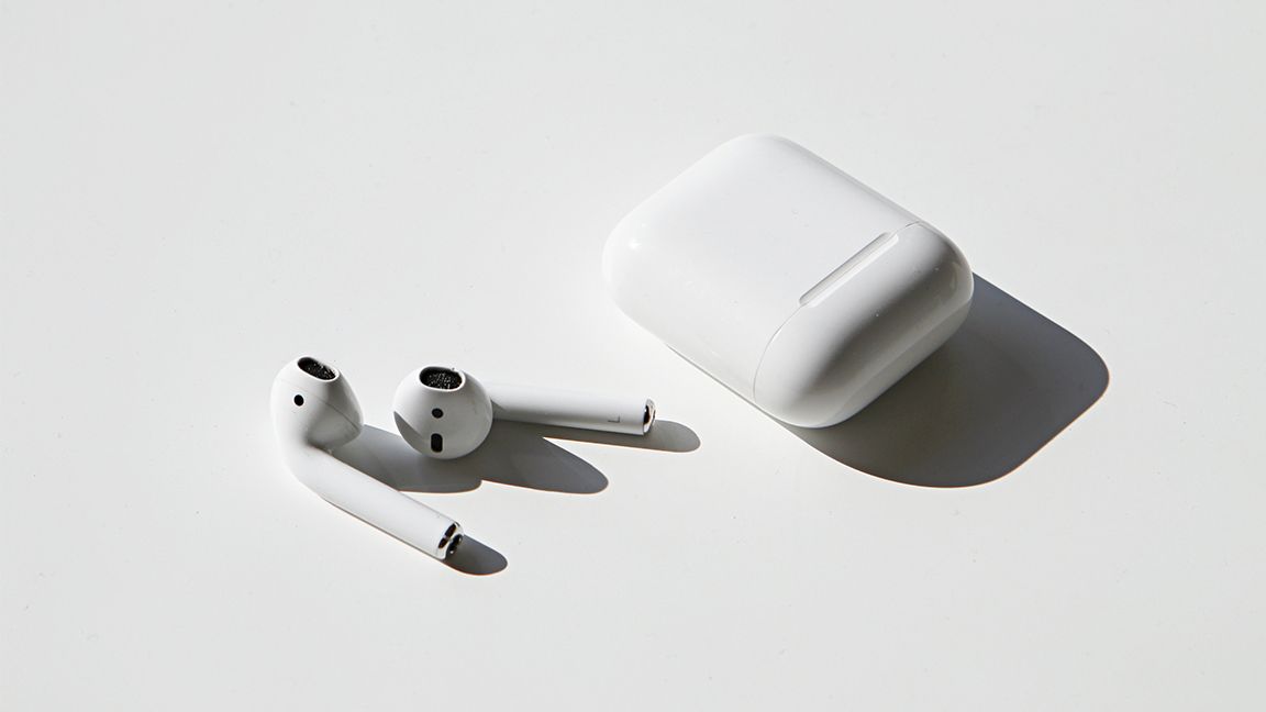 AirPods sitting on a white table
