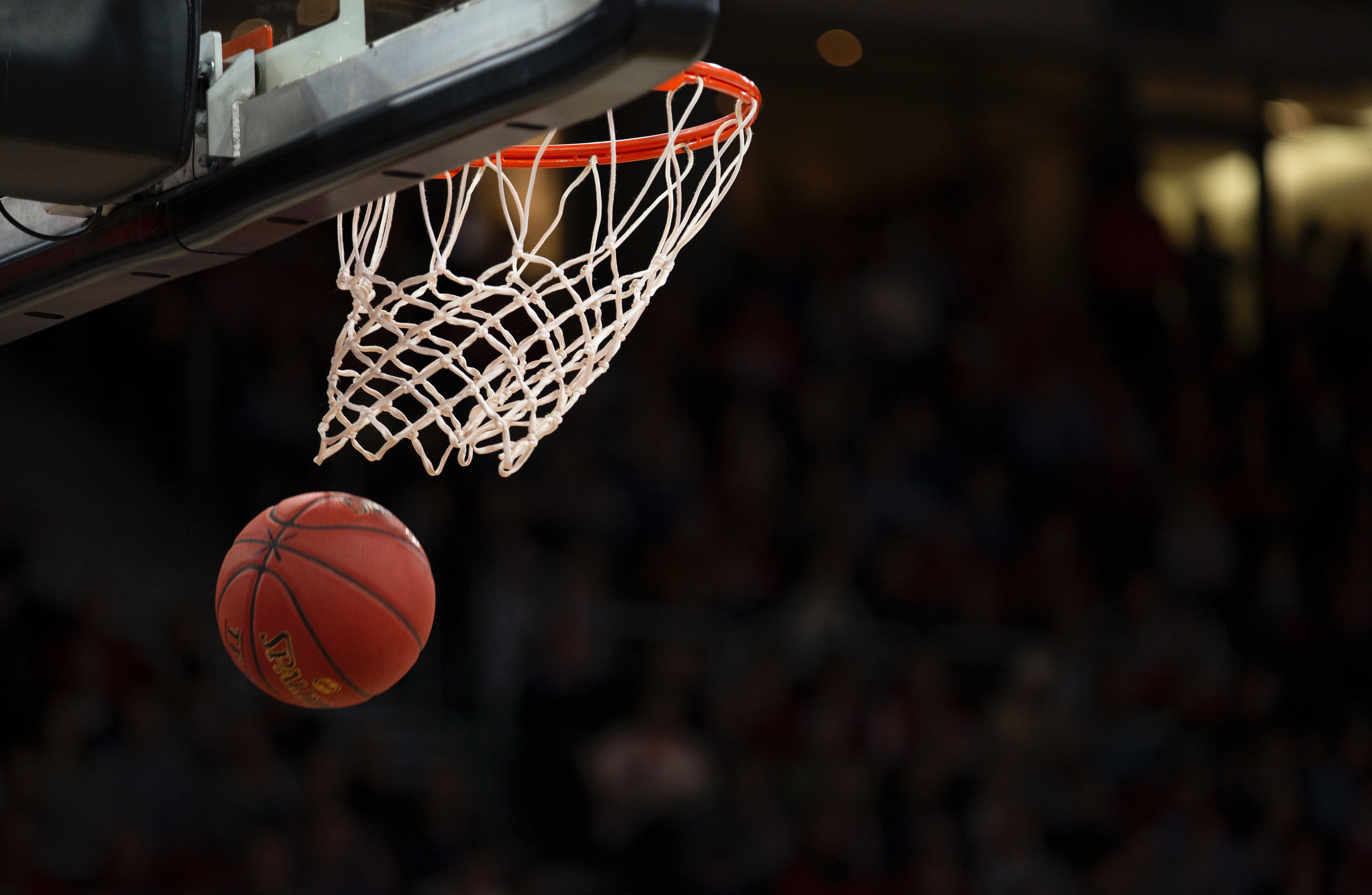 Photo of a basketball going through the net 