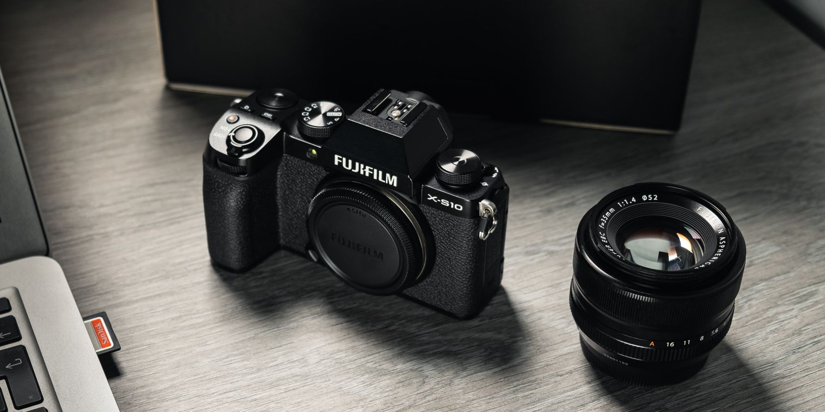 photo of a fujifilm camera and lens on the table