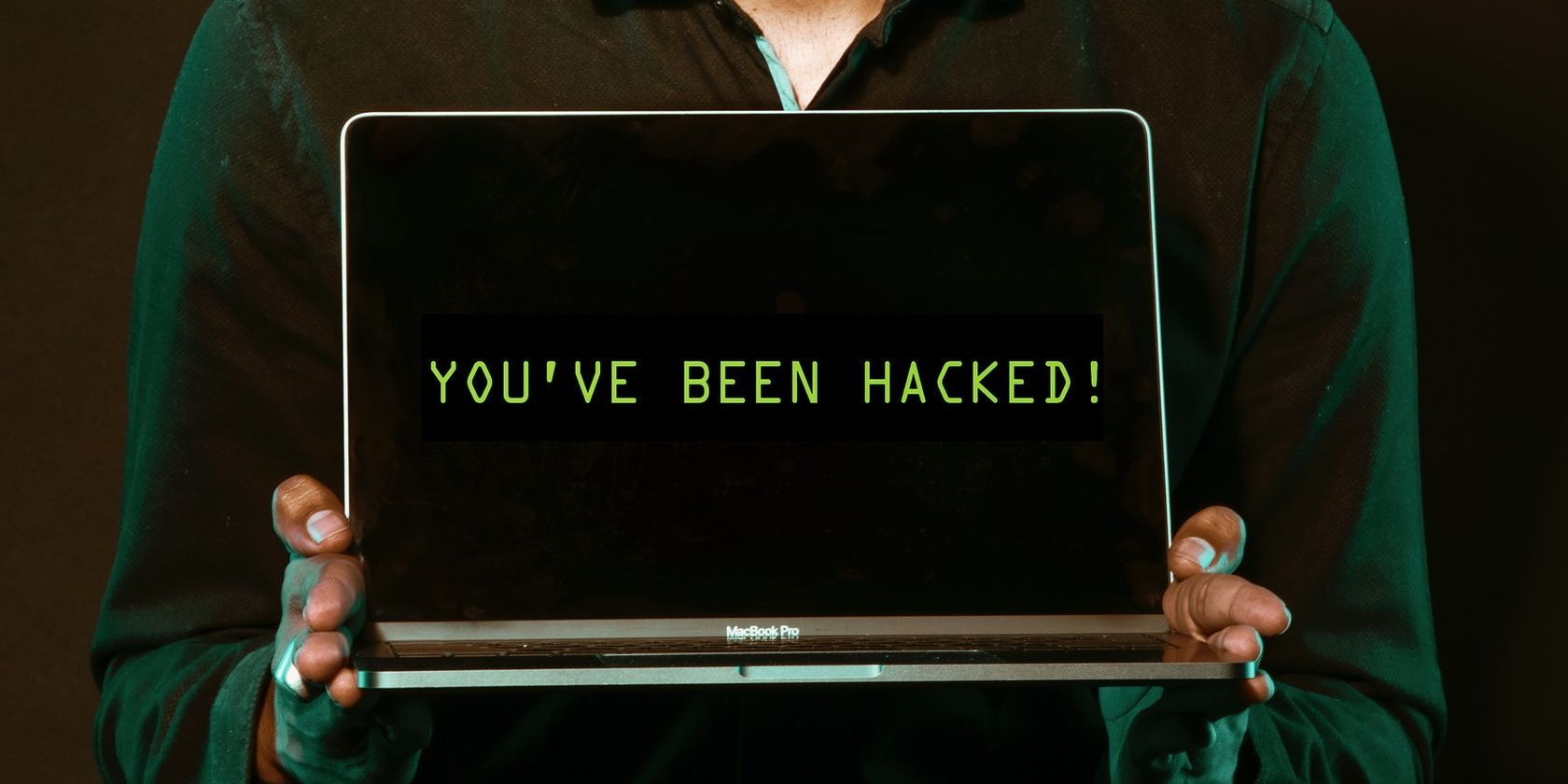 Person Holding Laptop Saying You Have Been Hacked