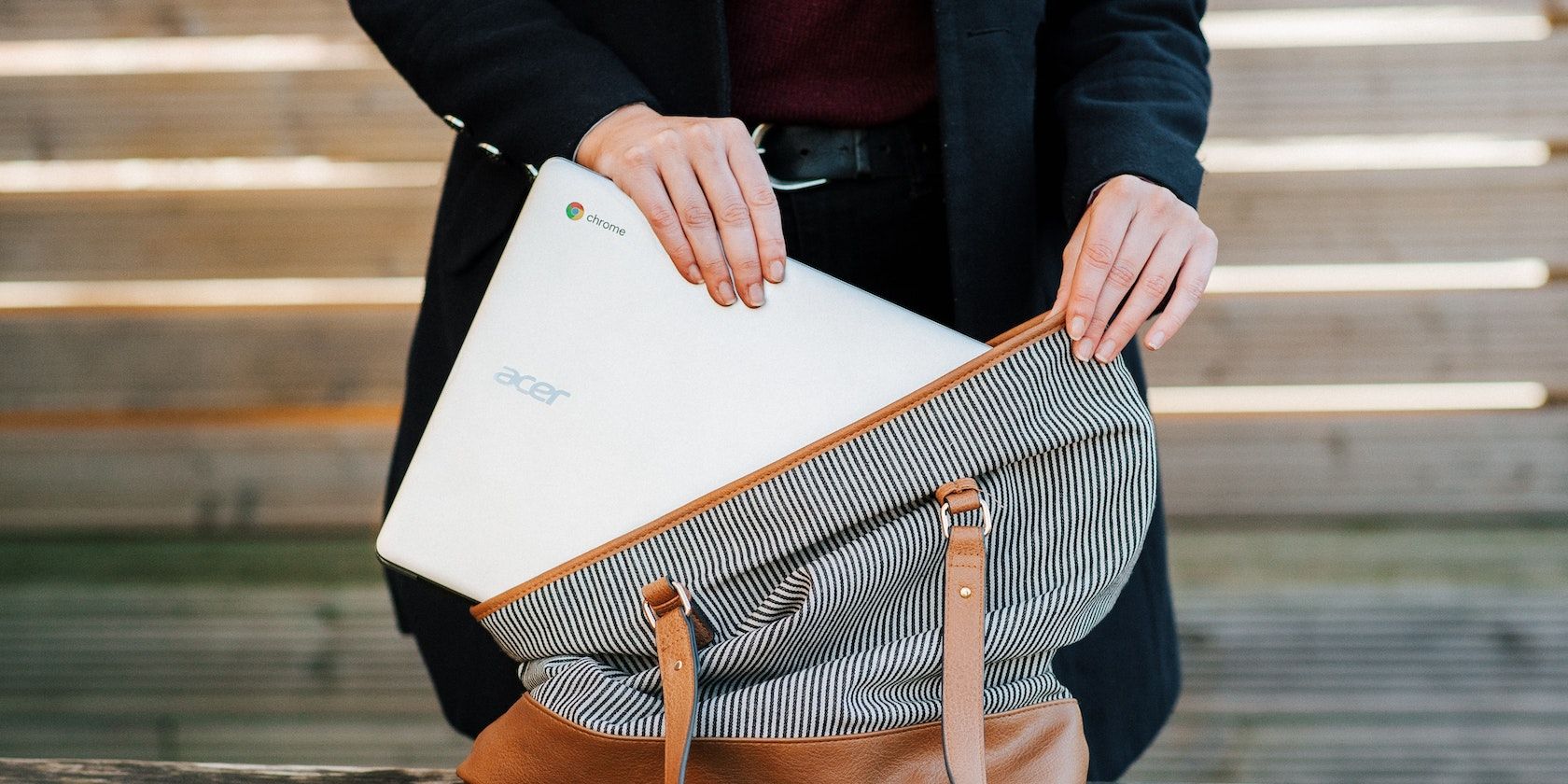 Person putting Chromebook in a bag featured