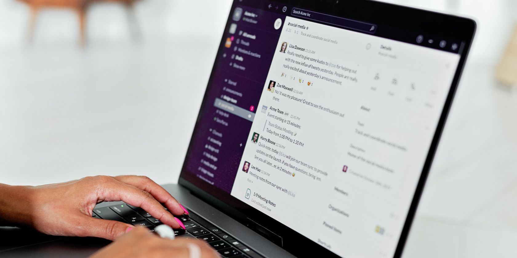 Image shows a woman using Slack on a laptop