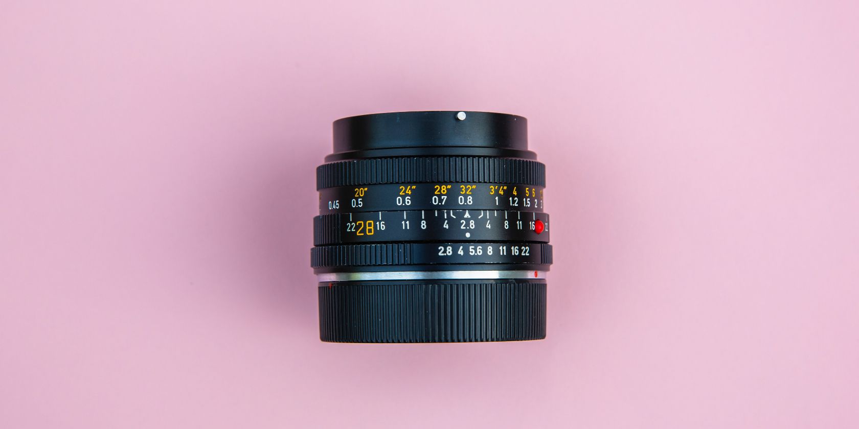 photo of a lens on a pink background