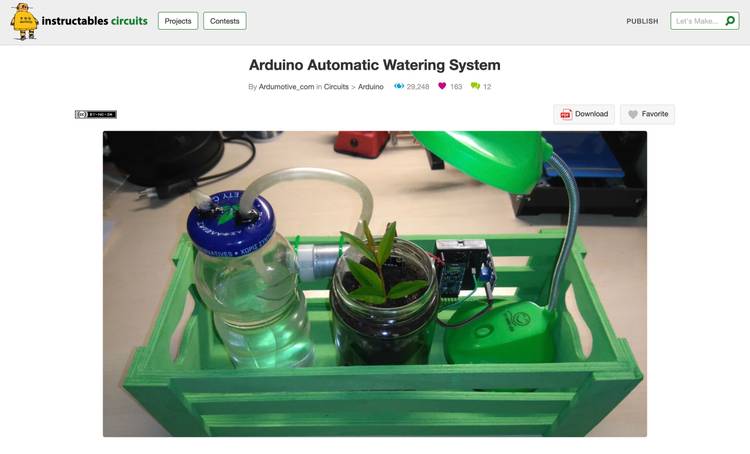 A scerenshot showing an image of a wooden box with a plant, a lamp, and a jar of water, connected with pipes and electronics